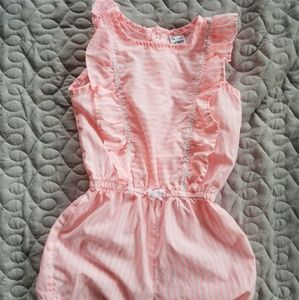 Coral and white toddler romper.